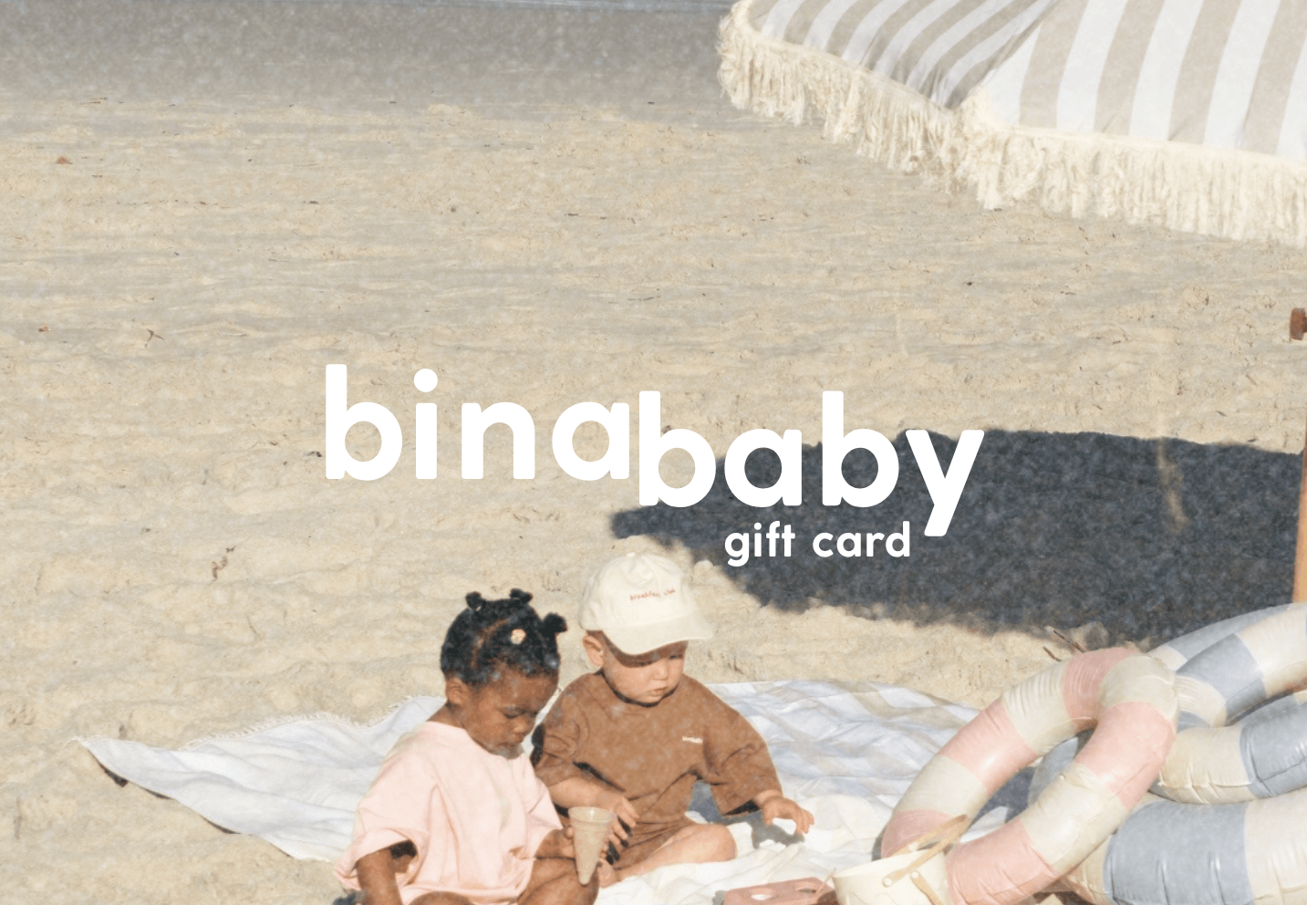 Two children playing on a blanket with 'binababy' gift card text overlay.